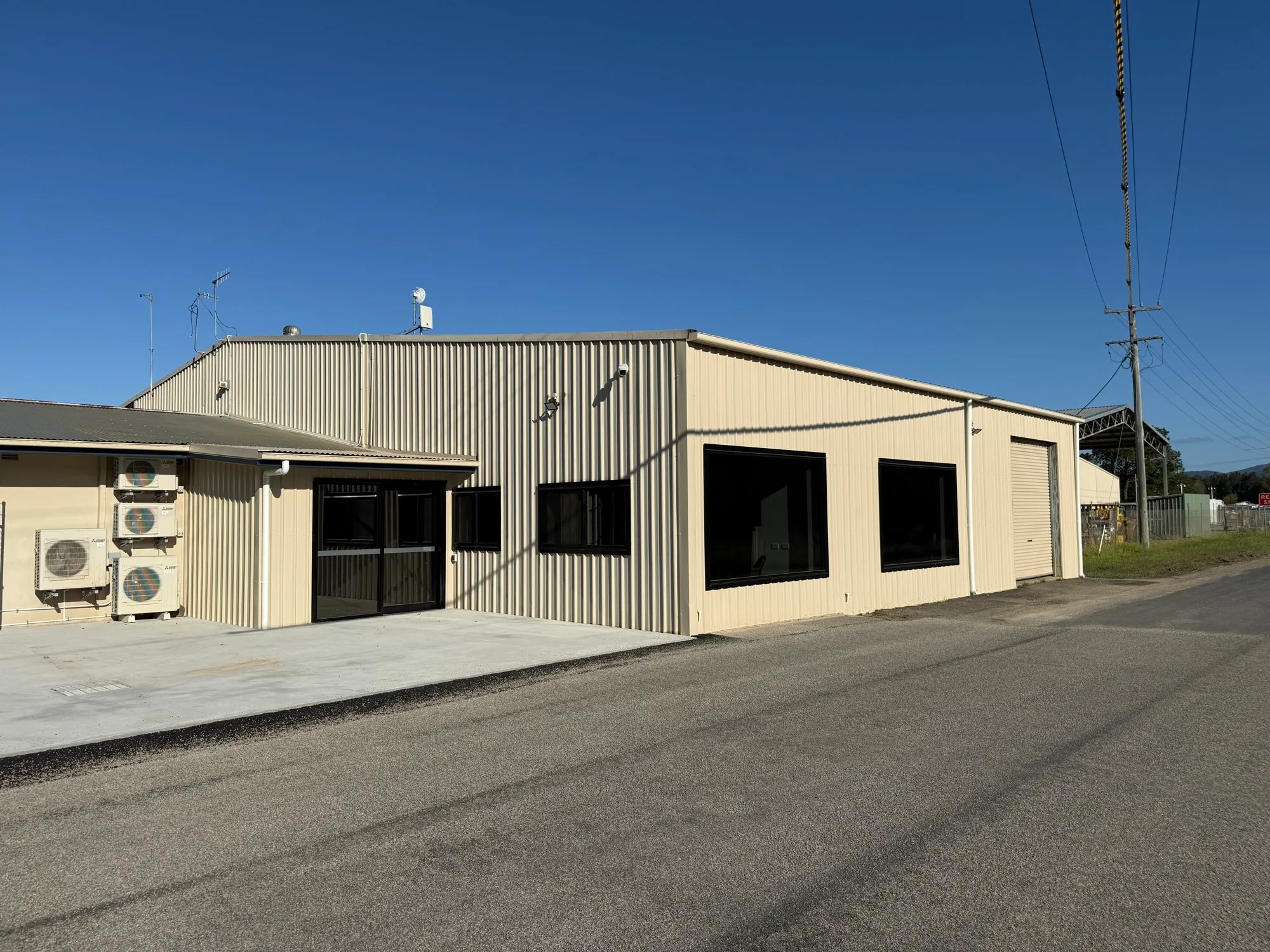 New Colorbond-clad office extension at the Nambucca Valley Council works depot, Macksville, with a new concrete apron and fresh asphalt